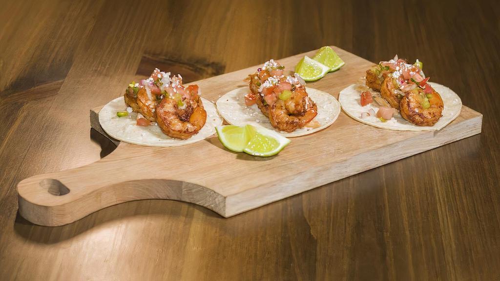 Shrimp Tacos · Seared shrimp on corn tortillas, topped with spicy slaw, chipotle crema, salsa verde and pico de gallo