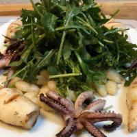 Calamari e Cannellini · Grilled Monterey calamari with cannellini beans and arugula.