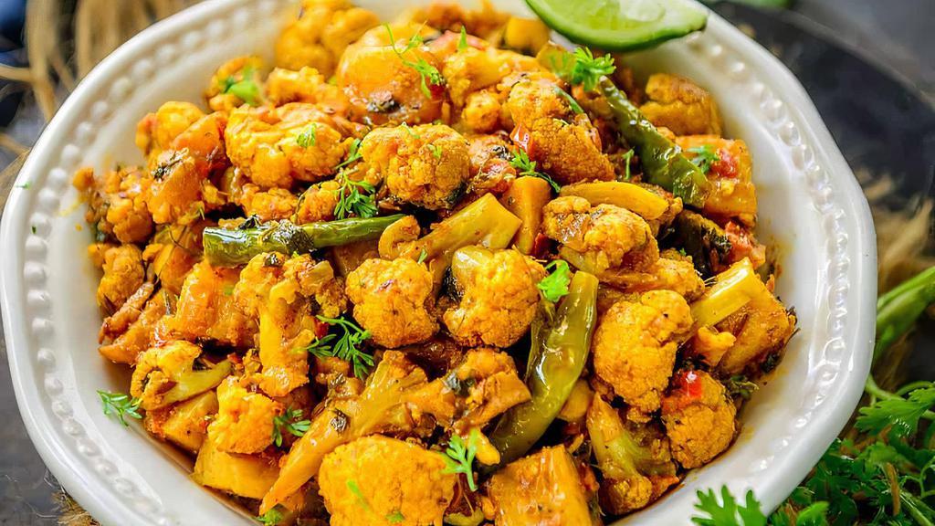Aloo Gobi · Boiled potatoes, cooked cauliflower, Indian spices cooked with homemade tomato sauce.