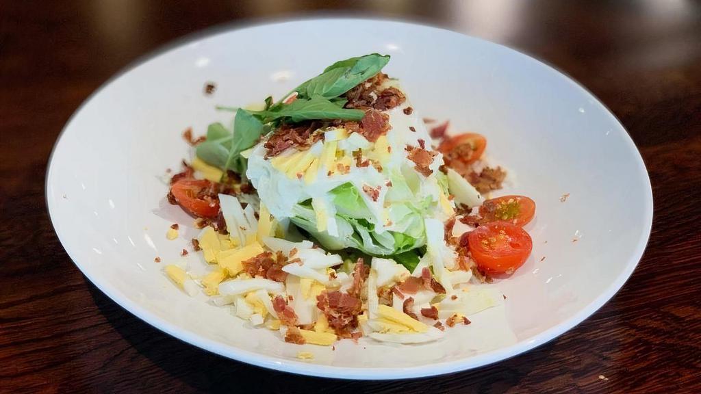 Iceberg Wedge · crumbled bacon, egg, Pt. Reyes blue cheese, Roquefort dressing