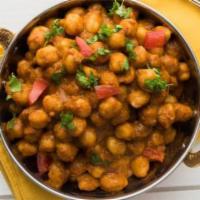 Chana Masala · Tender chickpeas prepared in a flavor curry infused with locally grown ginger, garlic, and c...