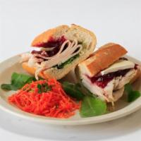 Roast Turkey Breast · With cranberry sauce and French brie cheese. Potato on the side.