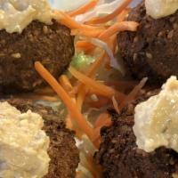 Falafel (4 Pcs) · Middle Eastern dish of spiced mashed chickpeas.