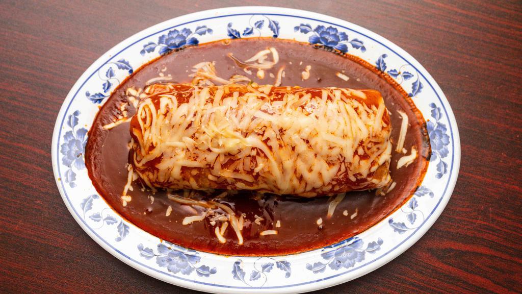 Burrito Mojado · Choice of meat, rice, beans, salsa, pico de gallo, guacamole, cheese on top.