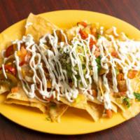 Super Nachos · Chips, choice of meat, choice of beans, guacamole, sour cream, cheese, jalapenos, and pico d...