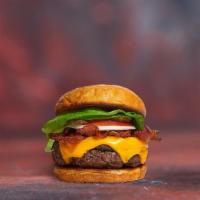 Vegan Bacon Burger · Seasoned plant-based patty topped with melted vegan cheese, layers of crispy vegan bacon, le...