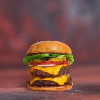 Vegan Double Cheese Burger · Two seasoned plant-based patties topped with melted vegan cheese, lettuce, tomato, onion, an...