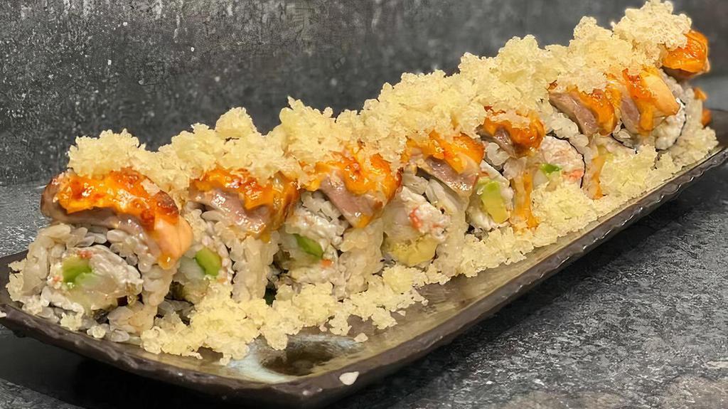 First Friday (Baked) · Shrimp tempura, imitation crab, avocado, topped with salmon, 421 sauce, unagi sauce, and tempura crunch.
