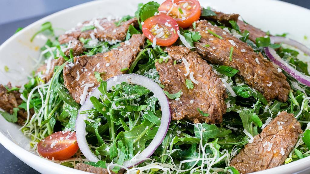 Tuscany Salad · Organic arugula, steak, cherry tomatoes, red onion, alfalfa sprouts and parmesan cheese with pesto dressing topped with herb mixes.
