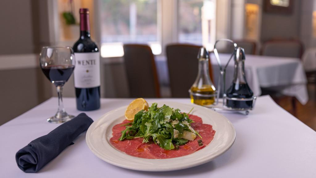 Carpaccio · Thinly sliced beef eye of round, baby arugula, capers, shaved parmesan cheese, Dijon mustard