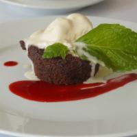 Tortino de Cioccolato · Decadent flowerless chocolate cake, topped with fresh raspberry sauce and vanilla gelato