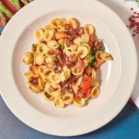 Orecchiette · Shell-shaped fresh pasta, applewood smoked bacon, green peas, fresh tomato, garlic, extra vi...