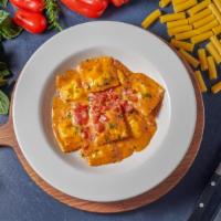Cheese Ravioli · Tossed in a roasted tomato and garlic cream sauce