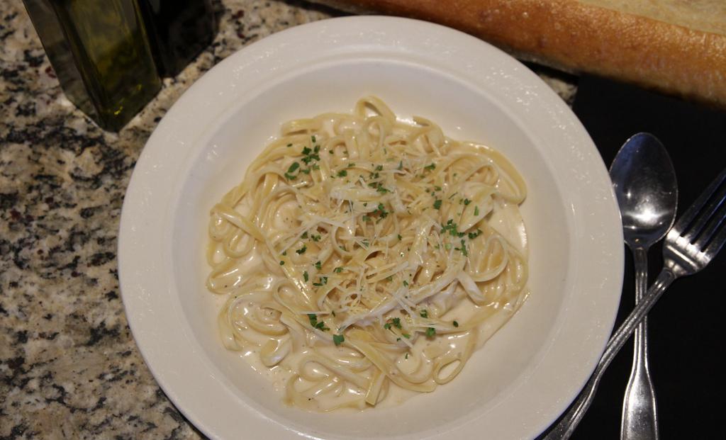 Fettuccine Alfredo · Tossed with mushrooms, Pecorino Romano, and our garlic cream sauce.