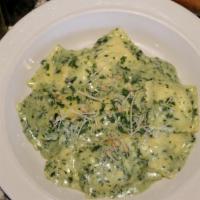 Asiago Cheese Ravioli · Pesto garlic cream sauce and pine nuts