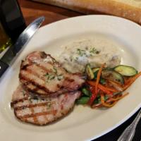 Smoked Pork Chops · Applewood smoked with roasted garlic butter and served with roasted garlic mashed potatoes a...