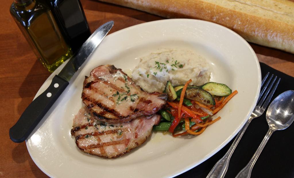 Smoked Pork Chops · Applewood smoked with roasted garlic butter and served with roasted garlic mashed potatoes and pan roasted veggies.