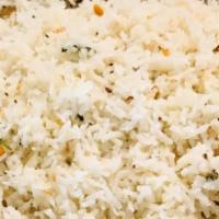 Tamarind Rice · South Indian rice flavored with tamarind, peanuts, curry leaf, and mustard seeds.