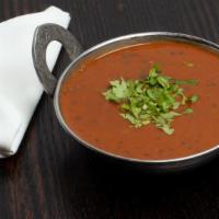 Daal Tadka · Traditional red and black lentil cooked in butter and creamy sauce with fresh spices.