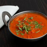 Chicken Tikka Masala · Oven grilled boneless breast meat cooked in onion and tomato sauce.