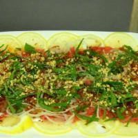 Lemon Beef / Bò Tái Chanh · Thinly sliced raw beef dressed in zesty juices and topped with fresh Asian basil, sliced oni...