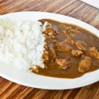 Chicken Curry · Pieces of grilled chicken in curry sauce served with steamed rice and house special pickles.