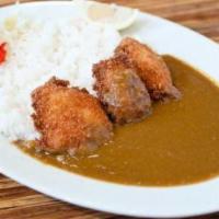 Salmon Fry Curry · Salmon cutlet served with curry sauce, steamed rice, and house special pickle.
