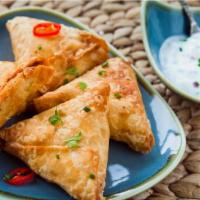 Sambusa · Classic Persian potato pastry with herbs and chutney on side.