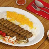 Beef Koobideh · Beef flavored Persian kabobs beded on saffron basmati rice and grilled tomato.