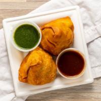 Samosa · Deep fried crispy flour pastry stuffed with potatoes, peas, coriander seeds and spices.