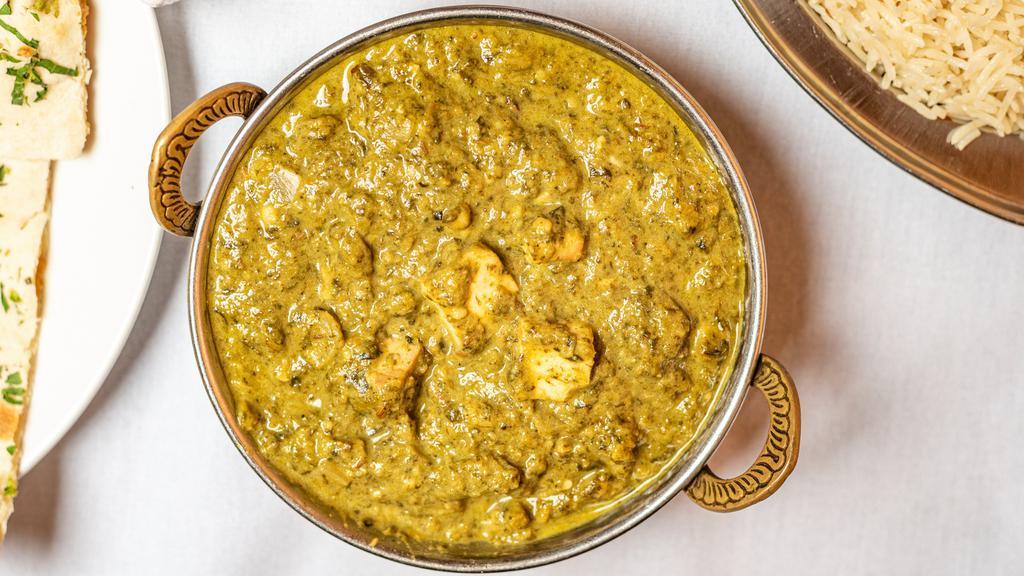 Saag Paneer · Home made cottage cheese cubes cooked with fresh spinach leaves with thick gravy of ginger, garlic, yellow and red onions, tomatoes, little dairy and many more famous Indian spices.