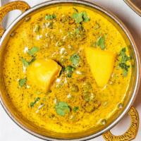 Aloo Mattar · White potatoes cooked with green peas, cumin, yellow and red onions, ginger, garlic and toma...
