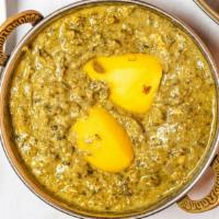 Saag Aloo · White potatoes cooked with fresh spinach leaves with thick gravy of yellow and red onions, g...