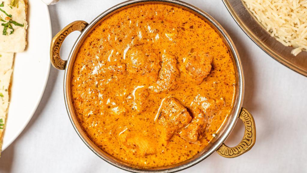 Chicken Tikka Masala · Tandoori baked chicken breast cooked in a smooth dairy curry with a touch of saffron with yellow and red onions, ginger, garlic, vine ripened tomatoes and spices.