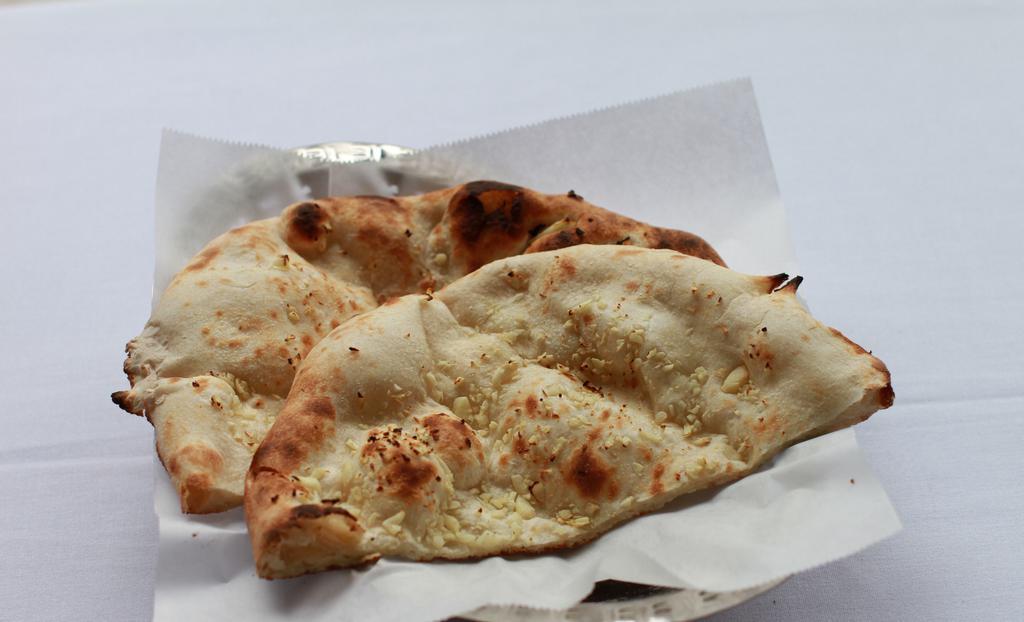 Garlic Naan · White flour bread garnished with freshly chopped garlic baked in tandoor.