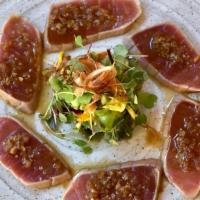 Tuna Tataki · Lightly Seared Big Eye Tuna with Yuzu Shallot Dressing, Japanese Herbs and Avocado.