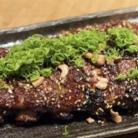 Glazed Baby Back Ribs · Topped with cashew nuts and green onion with glaze sauce and lime on the side.