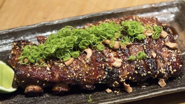Glazed Baby Back Ribs · Topped with cashew nuts and green onion with glaze sauce and lime on the side.