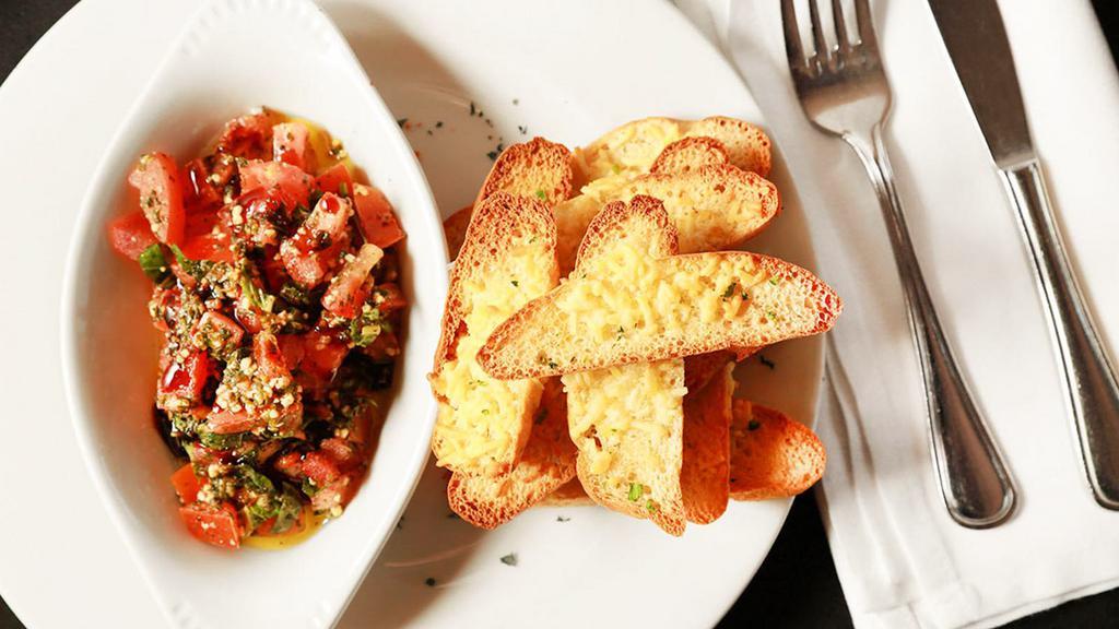 Bruschetta · Gorgonzola and garlic toast served with tomato and pesto bruschetta relish.