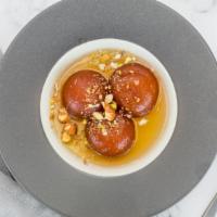 Gulab Jamun · Popular Indian sweet made with milk solids soaked in sugar syrup and rose water
