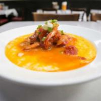 Shrimp & Grits with Spicy Tomato-Bacon Gravy · Sauteed shrimp over cheddar grits. Spicy tomato-bacon gravy. Gluten-free