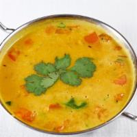 Dal Tadka · Vegan. Split yellow lentil seasoned with tomatoes and garlic, and flavored with a spiced oil...
