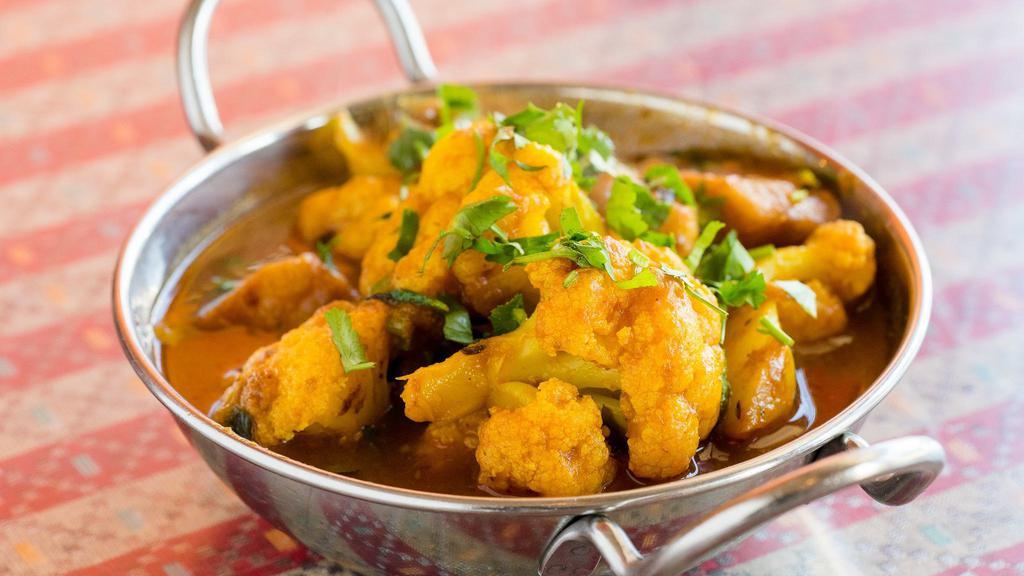 Aloo Gobi · Vegan. Pan fried potato, onions, and cauliflower served in a little house special curry sauce.