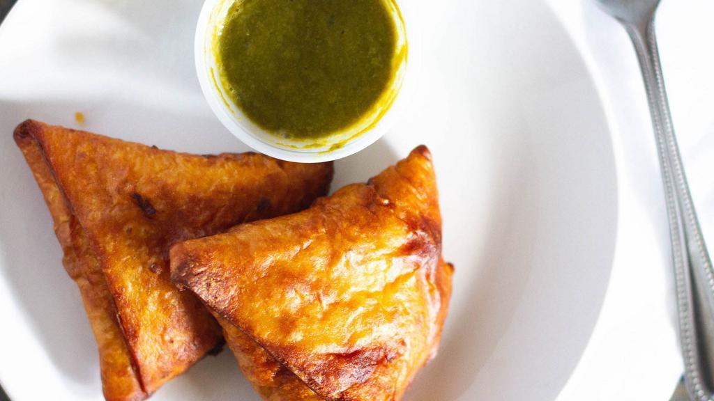 Vege Samosa (2 Pcs.) · Crispy turnover stuffed with potatoes, green peas, spinach, and fresh Indian spices.