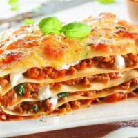 Meat Lasagna · Italian styled stacked lasagna made with fresh warm marinara sauce and beef.
