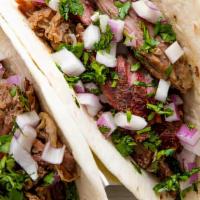 2 Coco Cola Braised Carnitas Tacos · Diced Onion | Tomatillo Salsa | Cilantro