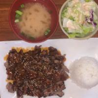 Beef Teriyaki · Grilled prime cut beef in a teriyaki sauce. Comes with miso soup, green salad and whit steam...