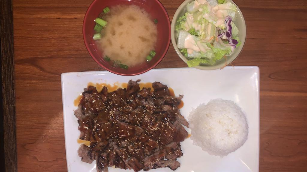 Beef Teriyaki · Grilled prime cut beef in a teriyaki sauce. Comes with miso soup, green salad and whit steam rice