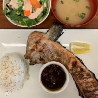 Salmon Kama · Grilled salmon neck with sea salt served with ponzu sauce, miso soup, green salad white rice.