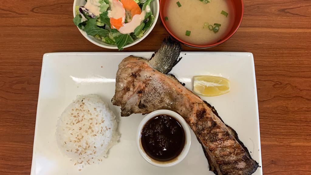 Salmon Kama · Grilled salmon neck with sea salt served with ponzu sauce, miso soup, green salad white rice.